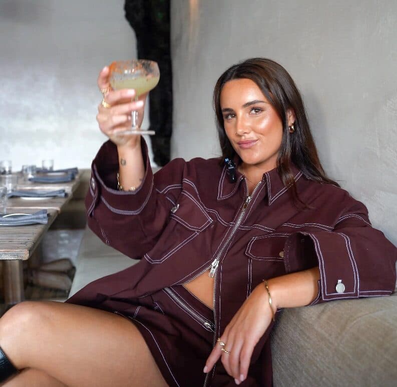 Jessie raising a cocktail